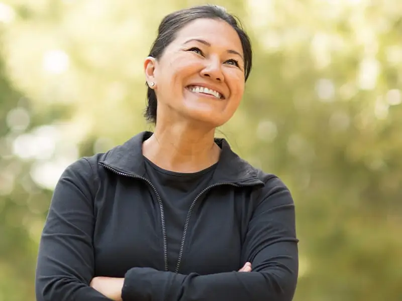 Asian woman looking up smiling