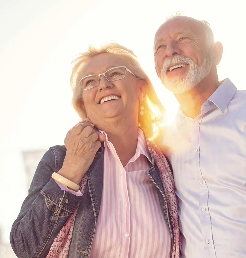 Older couple looking up smiling